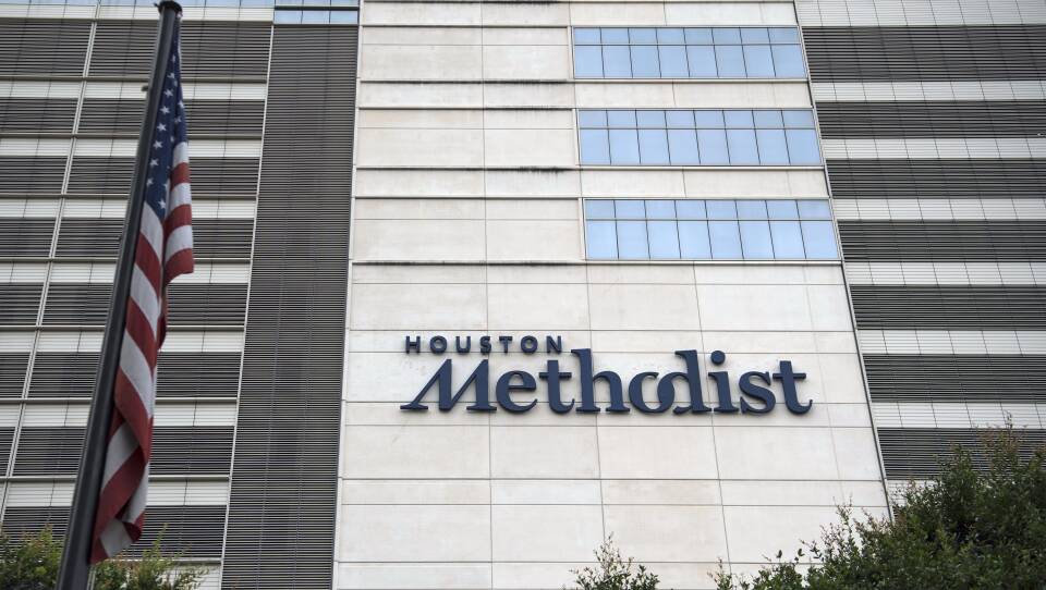 An American flag flies outside of Houston Methodist Hospital in June 2020. A federal judge has thrown out a lawsuit by hospital employees who have refused to comply with a mandate requiring they receive a COVID-19 vaccine.
