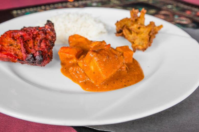 A plate of food from Shanti's buffet: basmati rice, onion bhaji, chicken tikka masala, tandoori chicken.
