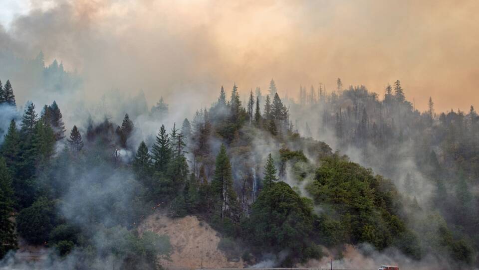 A fire truck drives along Highway 299 as the Carr fire continues to burn near Whiskeytown, California on Saturday.