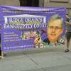 Two demonstrators protest against U.S. Judge Robert Drain, who has granted immunity from future opioid lawsuits to members of the Sackler family.