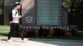 People walk by the campus of Yeshiva University in New York City on Aug. 30. The school told students in an email that it was pausing all student clubs on campus.