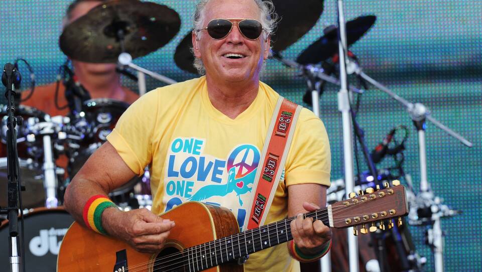 Musician Jimmy Buffett performs onstage at Jimmy Buffett & Friends: Live from the Gulf Coast, a concert presented by CMT at on the beach on July 11, 2010 in Gulf Shores, Alabama.