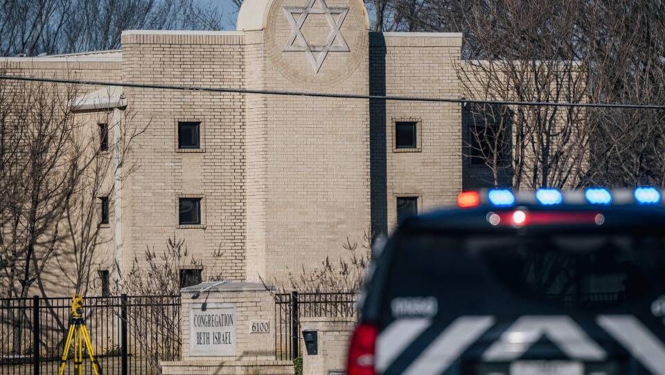 A law enforcement vehicle sits in front of the Congregation Beth Israel synagogue on January 16, 2022 in Colleyville, Texas. All four people who were held hostage at the Congregation Beth Israel synagogue have been safely released after more than 10 hours of being held captive by a gunman