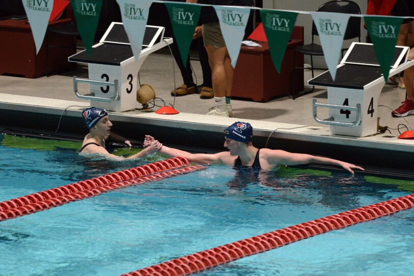 Two swimmers in a pool.
