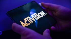 A visitor plays the game 'Call of Duty' of Activision on a mobile phone. (Ina Fassbender/AFP via Getty Images)