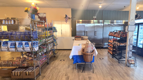 Wire shelves offer staples like soup cans and apple sauce containers.