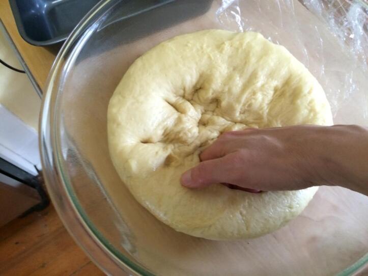 "Punching down" or deflating the dough after its first rise.