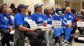 Sporting electric blue shirts, members of the Mass. Senior Action Council sit in a senate meeting space in preparation to advocate for a controversial tax plan.