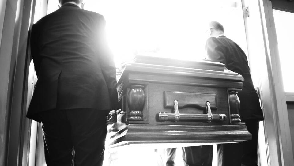 Rear View Of People Carrying Coffin