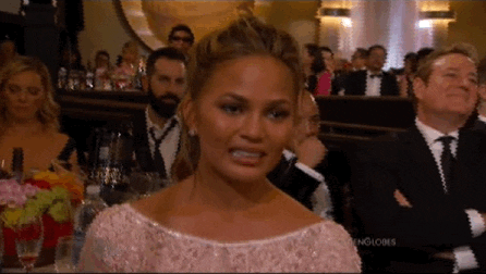 A woman makes an uncomfortable face