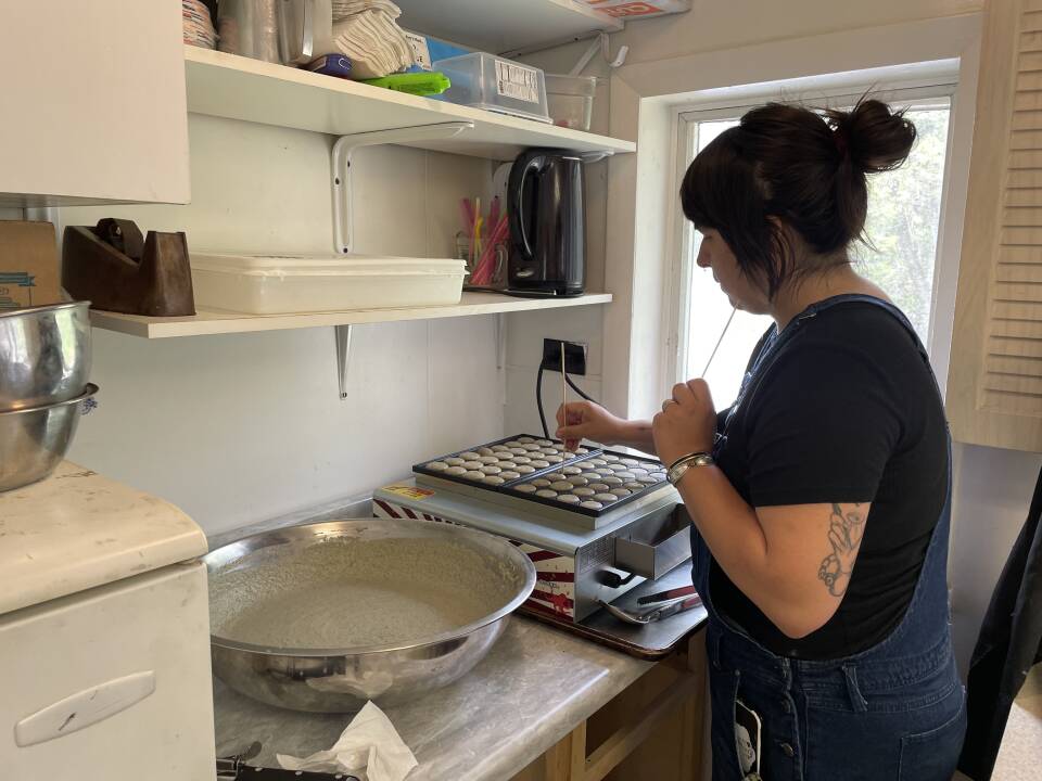 Jasmine Tintor bakes blue corn minis- a bite-sized pancake puff- on a Japanese squid grill at Katahdin Kitchen, a pop-up restaurant featuring indigenous cuisine in Veazie.