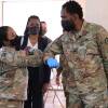 Nearly 130 million U.S. adults have completed their vaccine regimens, the CDC says, with another 70 million vaccine doses currently in the distribution pipeline. Here, Maryland National Guard Brig. Gen. Janeen Birckhead greets soldiers last week at a mobile vaccine clinic in Wheaton, Md.
