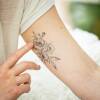 Stickler displays the poppy tattoo she got to commemorate her time on Broadway as an understudy for Elphaba in Wicked. After taking a coding boot camp, Stickler now works as a software engineer.