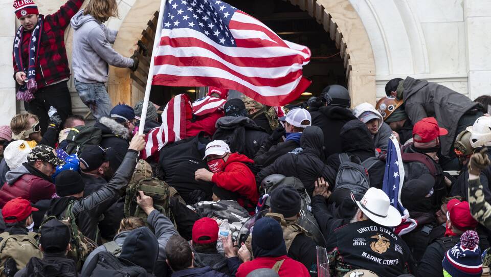 Rioters clash with police trying to enter Capitol building through the front doors. Rioters broke windows and breached the Capitol building in an attempt to overthrow the results of the 2020 election.