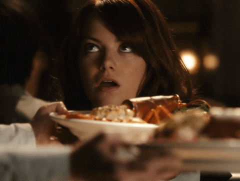 Woman exaggeratedly says "Yum!"