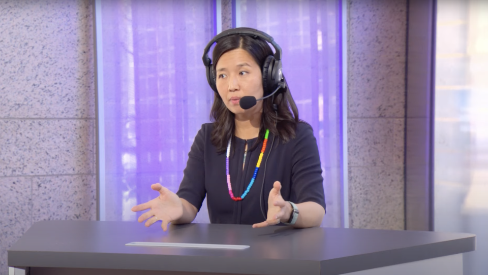Mayor Michelle Wu gestures with her hands as she speaks during a radio program.