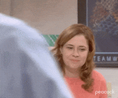 A woman smiles and hugs a piece of paper in excitment
