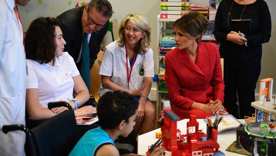 Melania Trump speaks with people during a visit to the Necker Hospital in Paris, on July 13, 2017.
