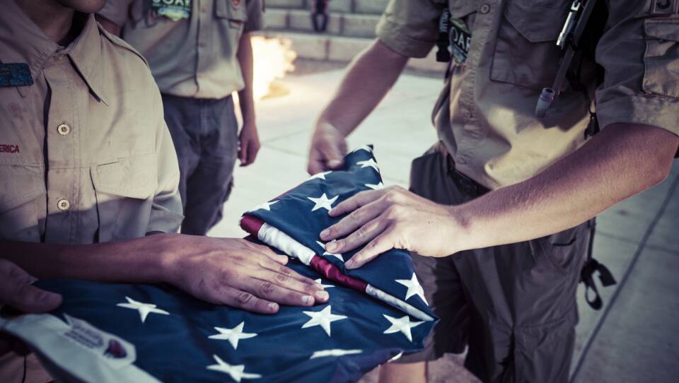 Boy Scouts fold an American flag during a ceremony at their camp in Colorado.