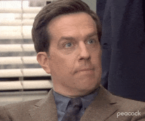 A man stares off camera and blinks deliberately