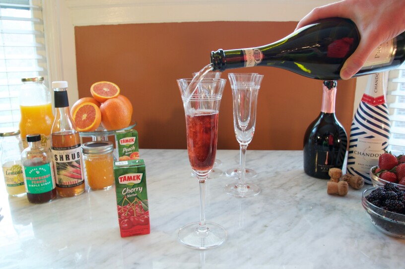Making a Mimosa t the DIY Mimosa Bar.