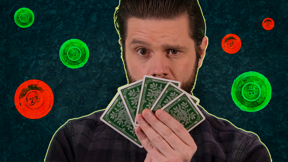 Edgar holds a hand of playing cards in front of his face. The background shows red and green poker chips.