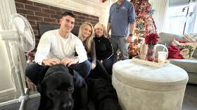 Gabriella Parker, second from left, an Orleans firefighter and paramedic, talked about the challenge of buying a house in today's Cape Cod real estate market, compared to what it was like for her firefighter father, Donald Parker, right. Seated with Parker are her boyfriend, Erik Simonsen, mother, Laurie Parker, and dogs Tuukka and Bella.
