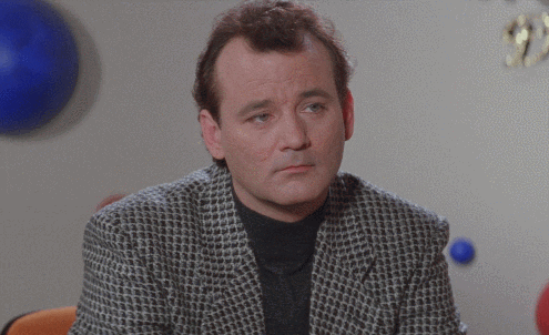 A man incredulously stares directly into the camera and blinks