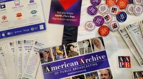 A collection of American Archive of Public Broadcasting pamphlets and merchandise, including stickers, buttons, and bookmarks