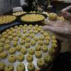 Palestinian women make traditional pastries filled with dates or nuts known as ma'amoul.