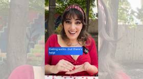 A woman in a red shirt and headband with text overlay reading "dating sucks... but there's help!" and a play button.