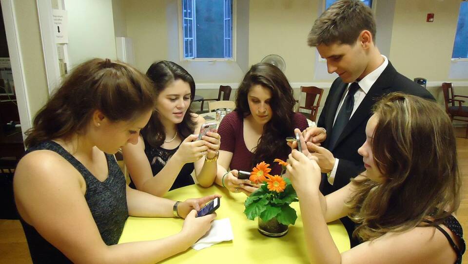 young_people_texting_on_smartphones_using_thumbs.jpg