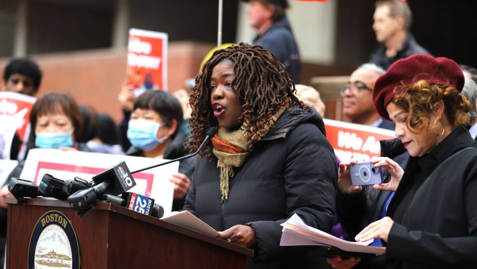 Ruthzee Louijeune speaks from a podium.