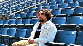 A young man sits in an empty stadium