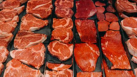 Rows of raw steaks, T-bones and other cuts of beef.