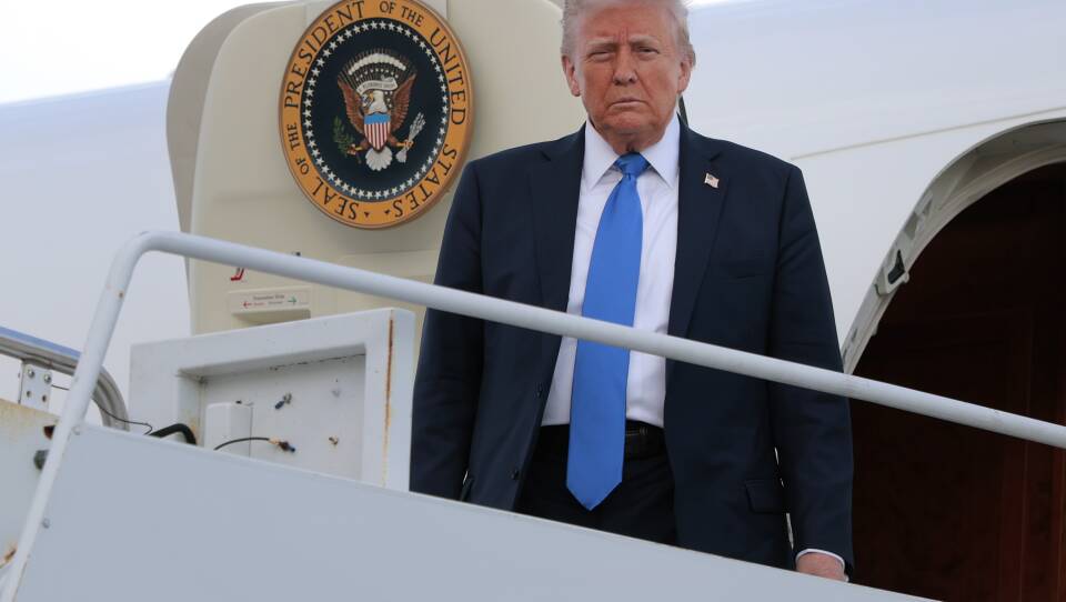 President Trump glares at the camera from the top of the stairway on Air Force One.