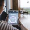 Woman using tablet with wifi symbol at home