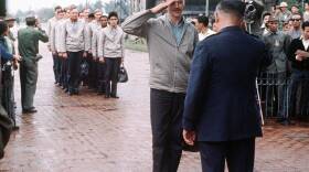 A photo from the release of American POWs from the "Hanoi Hilton" depicts Capt. John Parsels being saluted by the Gia Lam Airport returnee delegation