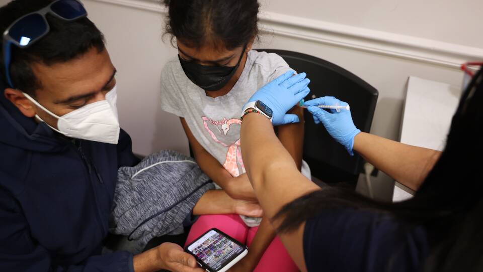 A child receives the Pfizer BioNTech vaccine at the Fairfax County Government Center in Annandale, Va., last November. Vaccines will soon be available for children as young as 6 months old.