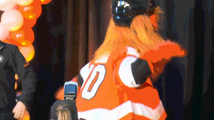 The NHL mascot Gritty, an orange monster, turns around in excitement