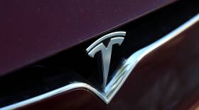 The Tesla logo is displayed on the front of a Tesla Model X in Los Angeles in 2017.