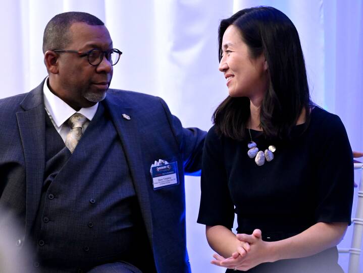 Mayor Michelle Wu and Sheriff Steve Tompkins are chatting off to the side at an event.