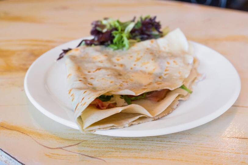 The “Affectation”, a savory crepe with bacon, goat cheese, arugula, and fig reduction.