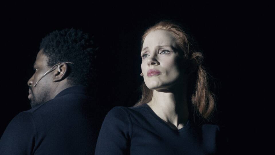 Jessica Chastain and Okieriete Onaodowan perform on a dark stage in "A Doll's House"