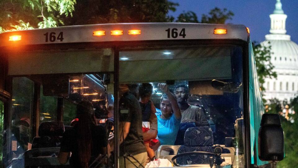 Migrants from Venezuela, who boarded a bus in Del Rio, Texas, disembark within view of the US Capitol in Washington, D.C., on August 2.