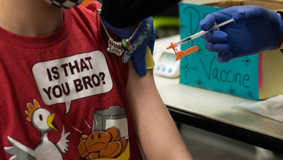 Pfizer and BioNTech say they will submit a formal request for emergency use authorization of the vaccine in young children "in the coming weeks," as they share data with the FDA about trials for kids from 5 up to 12. Here, a healthcare worker administers a dose of the vaccine to an older child at a pediatrician's office in Michigan.