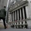 People pass the front of the New York Stock Exchange in New York, on March 22. Brinkmanship in Washington over raising the U.S. debt ceiling has begun to raise worries in parts of the financial markets.