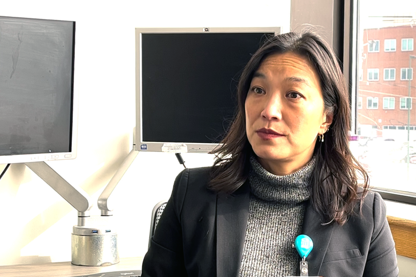 A woman in a turtleneck in an office
