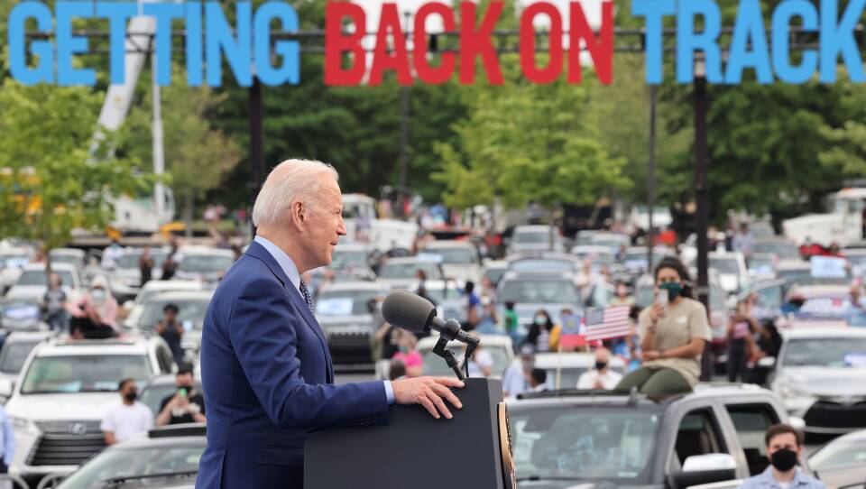 President Joe Biden speaks during the Democratic National Committee's "Back on Track" drive-in car rally in Duluth, Georgia, to celebrate his 100th day in office. Immigrant advocates were there to protest.