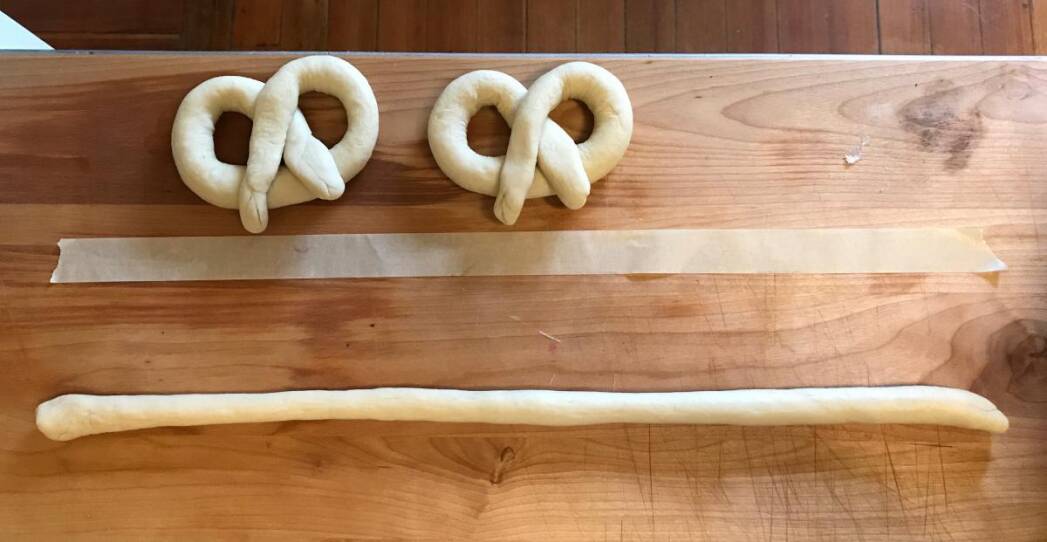 Roll consistently sized pretzels and stick a measured piece of tape to your counter before you start rolling.